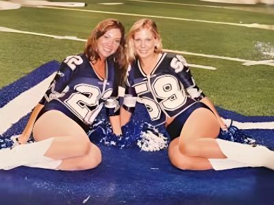 Emily Kuchar with her friend posing together as the Dallas Cowboys's cheerleader dress.